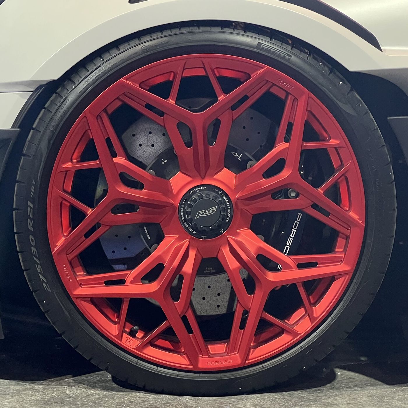 Pirelli P Zero tire on a red forged Porsche wheel, close-up