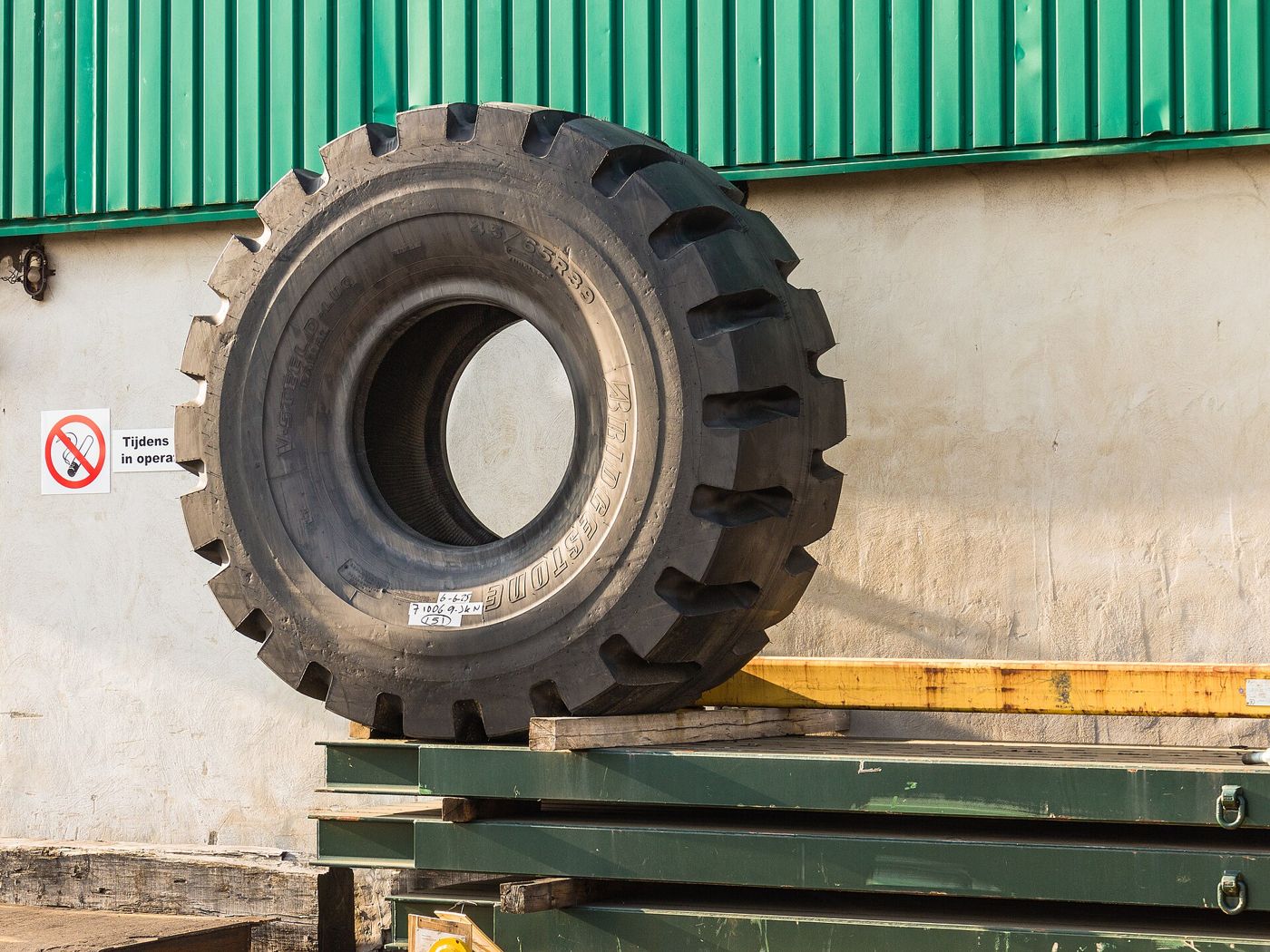 Giant Bridgestone off-the-road tire for heavy machinery, stored at a warehouse