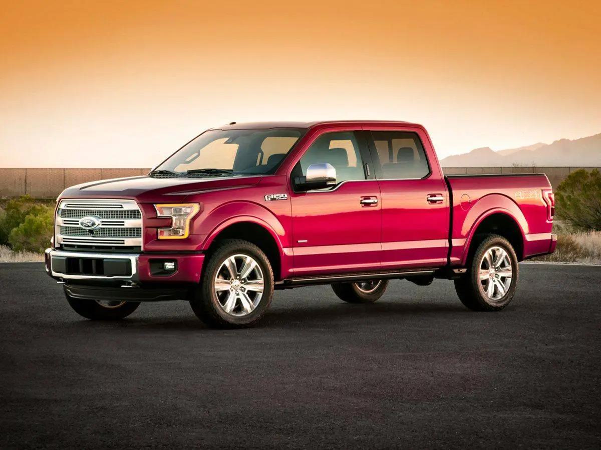 Red Ford F-150 pickup truck at sunset
