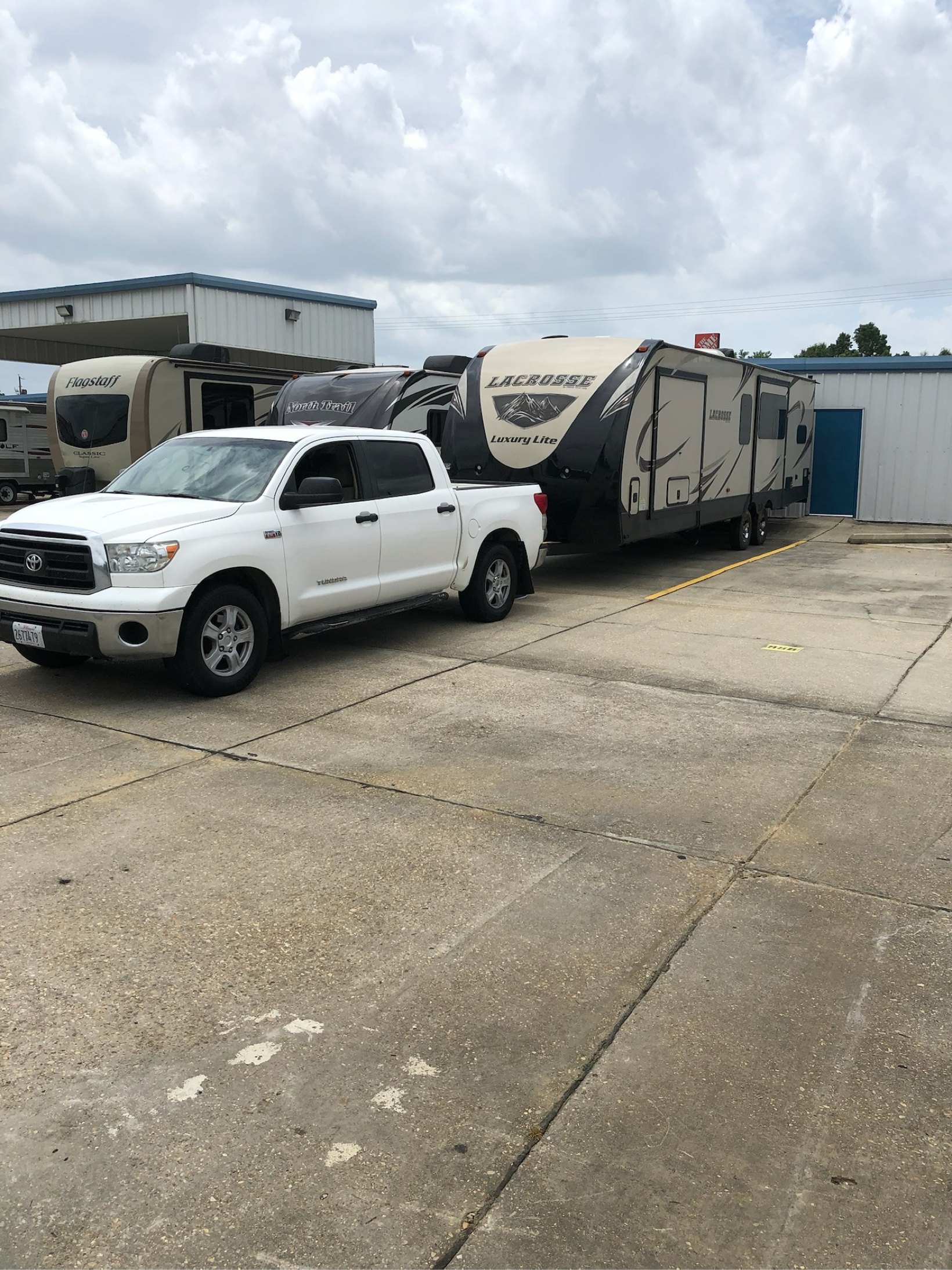 White Toyota Tundra pickup truck hitched to a Lacrosse travel trailer