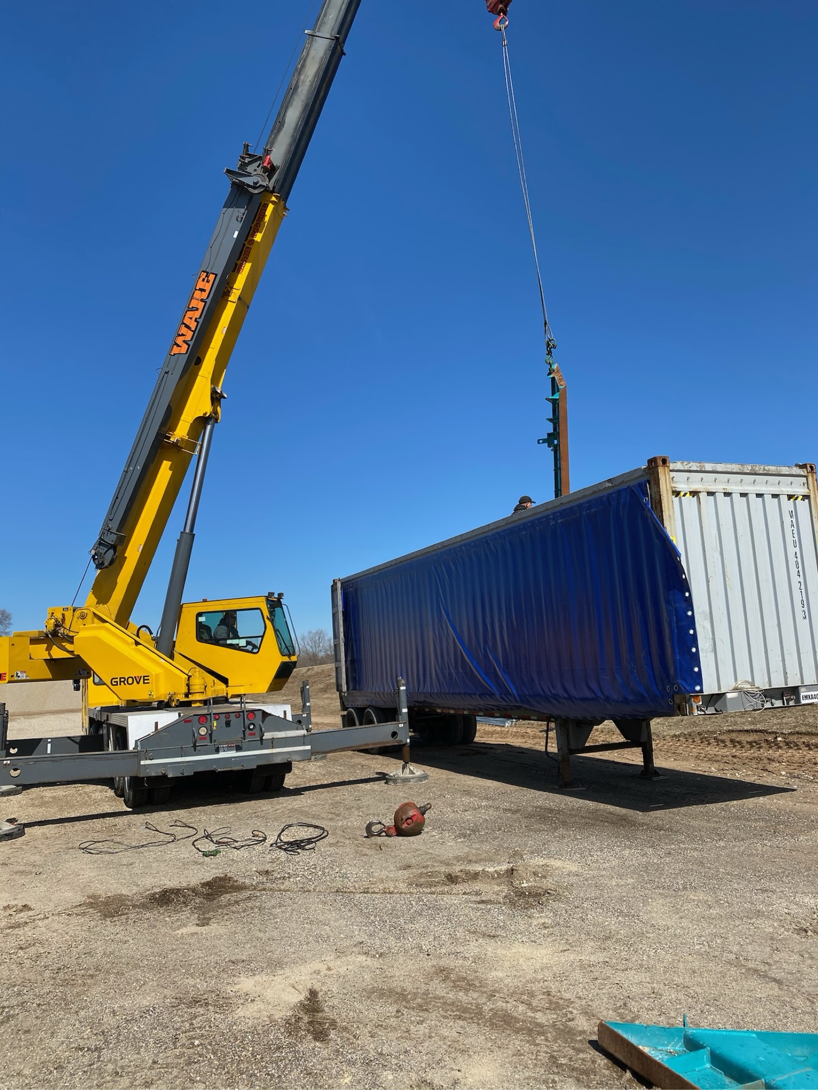 Yellow Grove mobile crane working at a shipping container